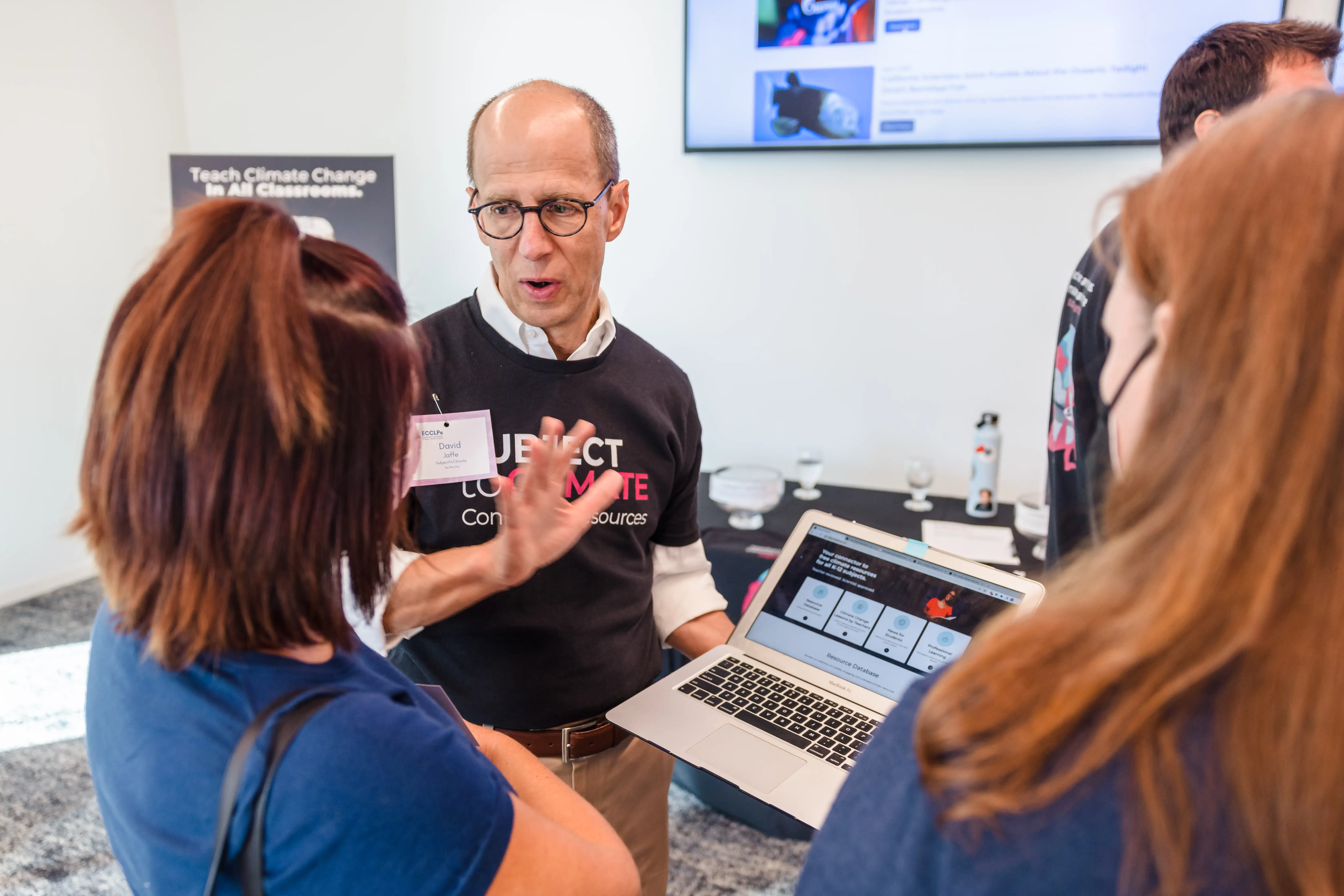 SubjectToClimate founder sharing resources with educators at an event
